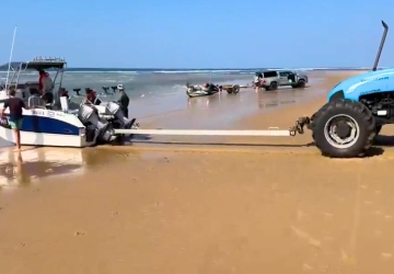 Deep sea fishing boat being launched by tractor at Baleia Azul Estate in Ponta Mamoli, Southern Mozambique.