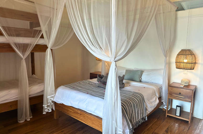 Bedroom with mosquito net at Aloha 29 in Ponta Mamoli