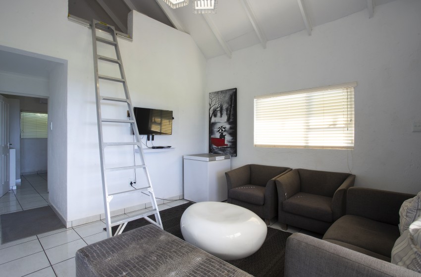 Living room with loft view at Baleia Azul 16 in Ponta Mamoli