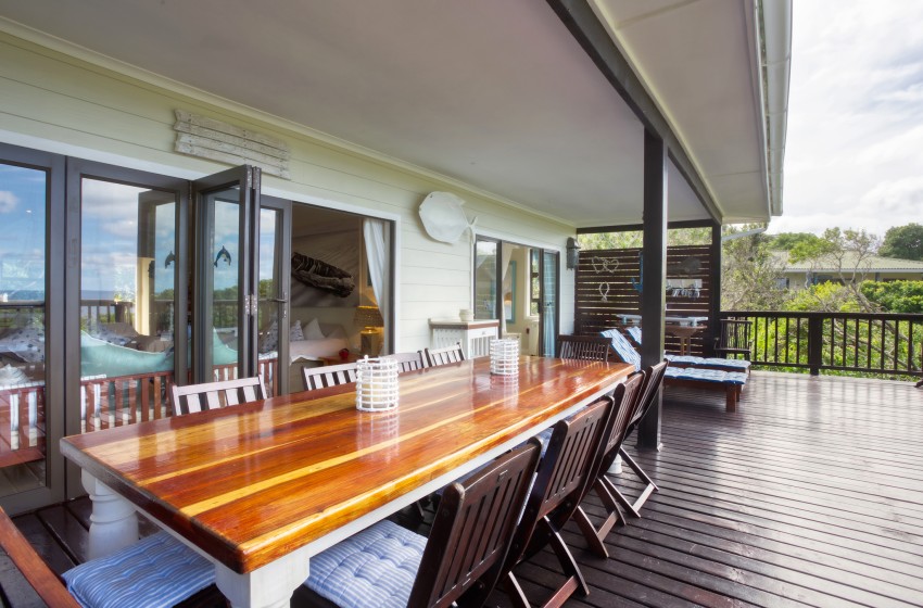 Deck with dining table at Campismo Ninho 40 in Ponta Malongane