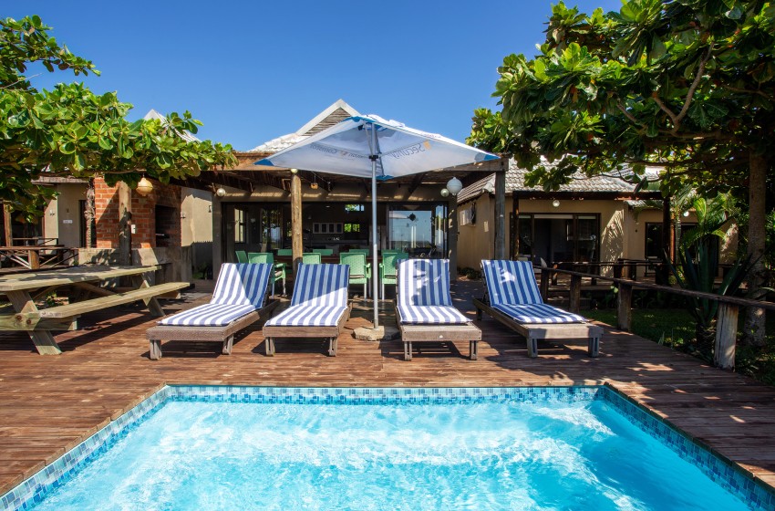 Swimming pool with sun loungers at Baleia Azul 15 in Ponta Mamoli