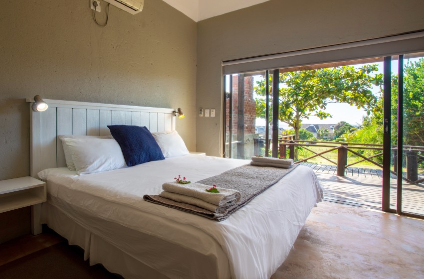 Bedroom 2 with view of garden at Baleia Azul 15 in Ponta Mamoli