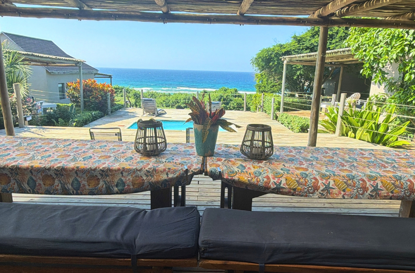 bench seating overlooking swimming pool at Baleia Azul 11 in Ponta Mamoli