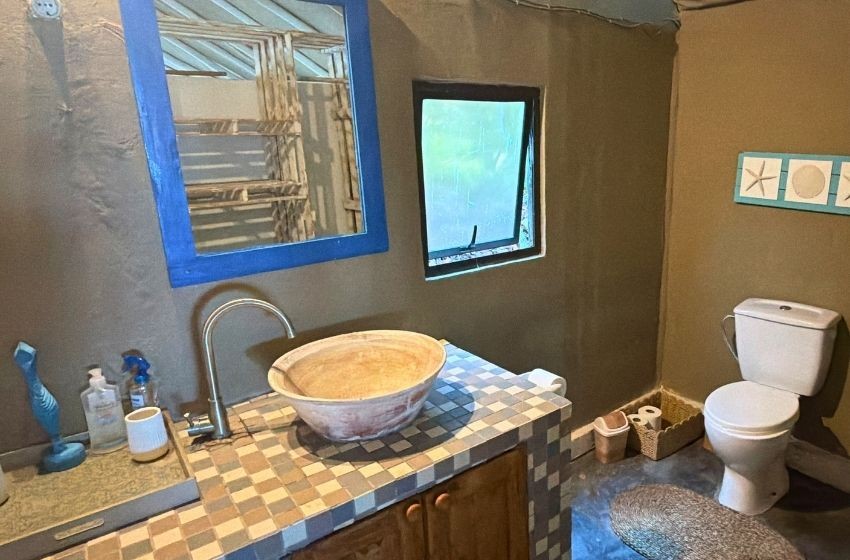 toilet and vanity at Baleia azul beachfront tent 8 in Ponta Mamoli