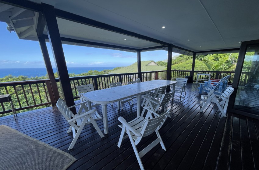 deck with dining table at campismo ninho 28 in Ponta Malongane