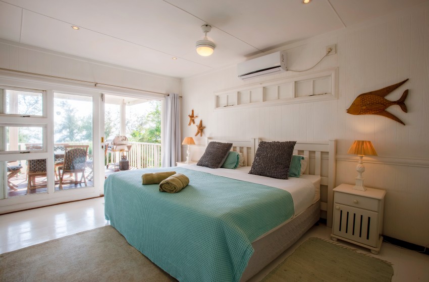 bedroom 1 with view of deck at Casa Branca in Ponta do Ouro