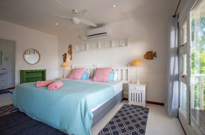 bedroom 2 with large window at Casa Branca in Ponta do Ouro